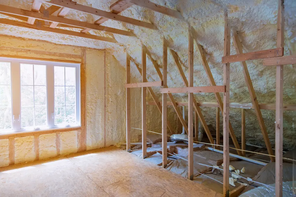 Home insulation installation in wall cavities to reduce heat transfer in South Florida residence